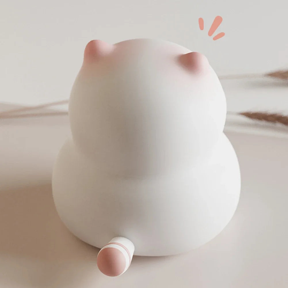 Cute cat night light with pink ears and tail on a neutral background