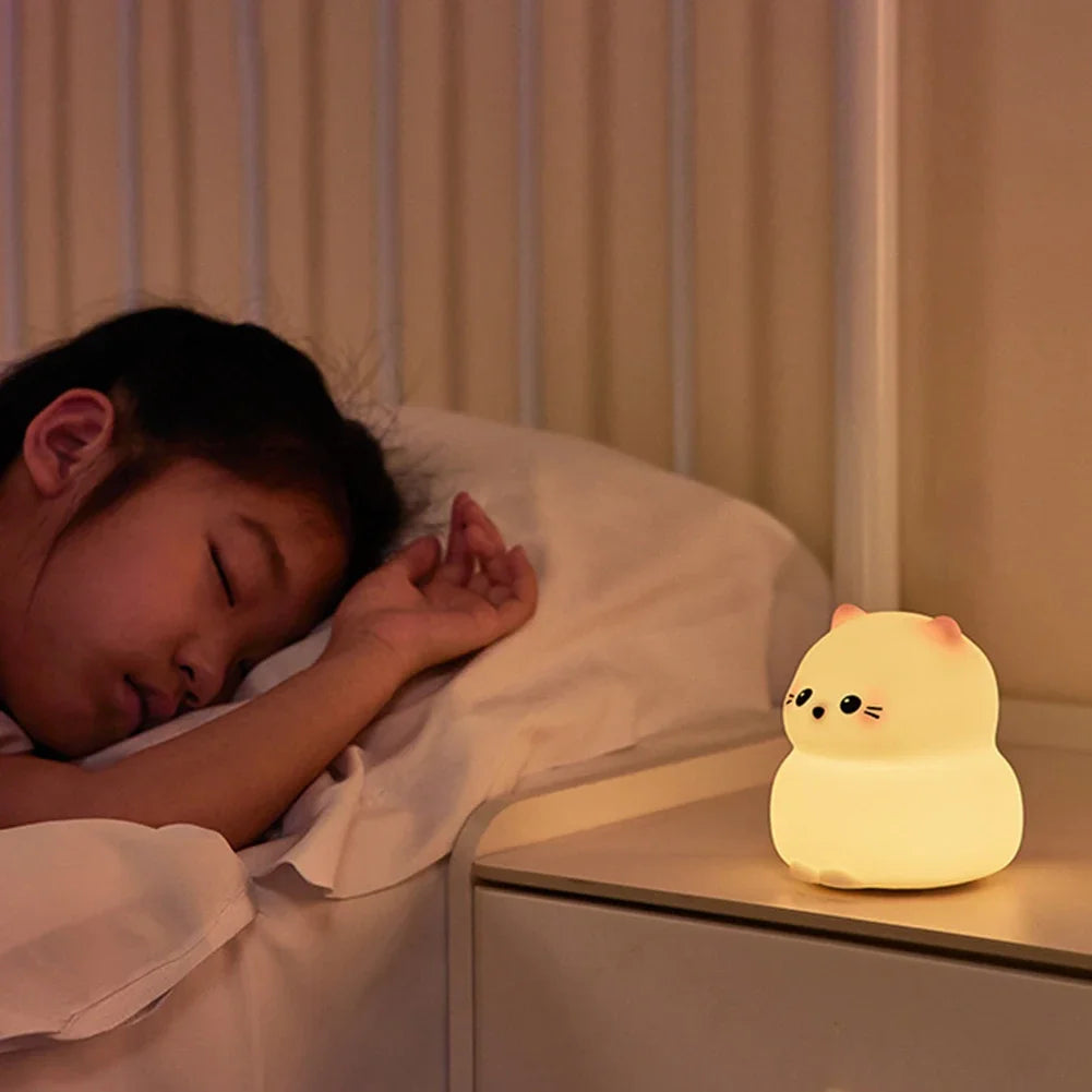 Sleeping child with cute cat-shaped night light on bedside table, warm glow, nighttime bedroom